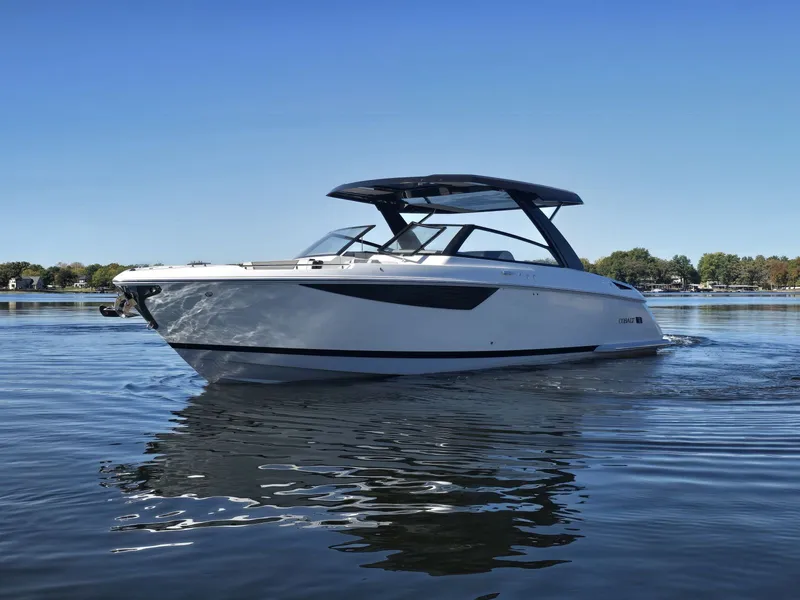 Slide: The Image of Cobalt R35 2025 boat on calm water under clear sky. - 4