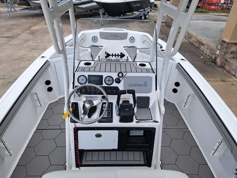 Slide: The Image of Interior view of a 2020 Yamaha 210 FSH Sport boat with helm console. - 17