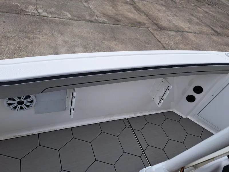 Slide: The Image of Interior view of a 2020 Yamaha 210 FSH Sport boat with gray flooring. - 24