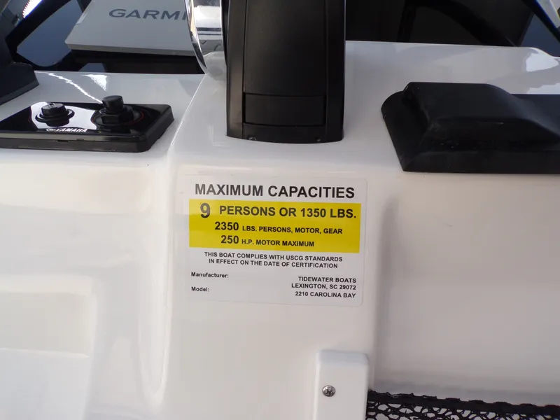 Slide: The Image of Tidewater 2210 Carolina Bay 2026 boat capacity label, maximum persons and weight limit. - 16