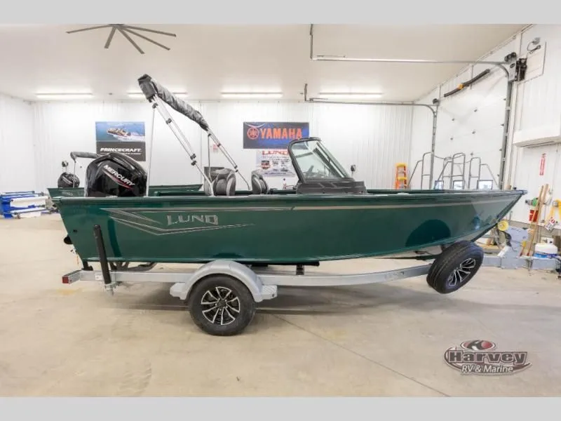 The Image of Green Explorer Sport 1800 boat on trailer in garage, year 2026. - 1
