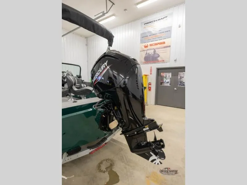 Slide: The Image of 2026 Explorer Sport 1800 with Mercury outboard motor in workshop. - 4