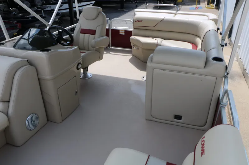 Slide: The Image of Interior of a 2016 Lowe SS190 pontoon boat with beige seating. - 19
