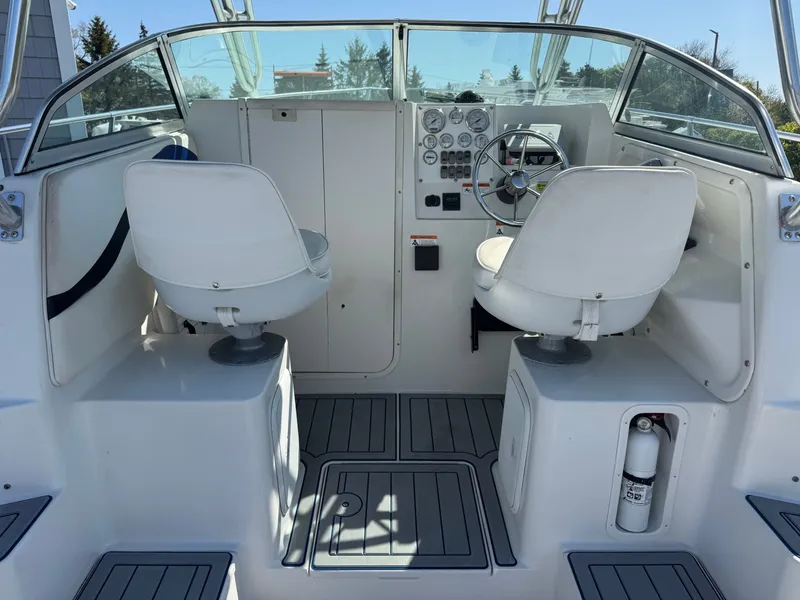 Slide: The Image of Interior of a 2004 Seaswirl Striper 2601 boat with helm console. - 11