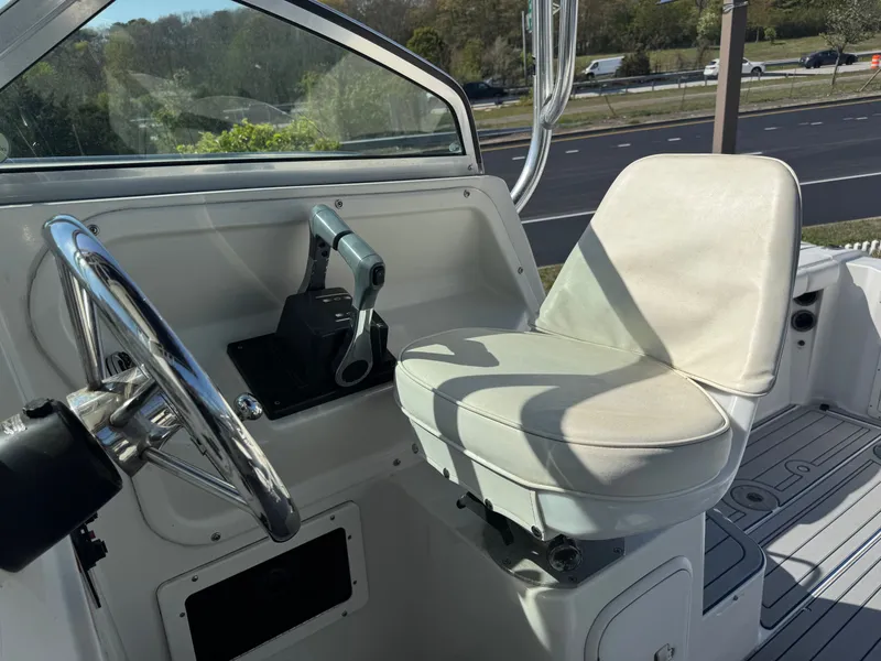 Slide: The Image of Interior of a 2004 Seaswirl Striper 2601 boat with helm and seat. - 13