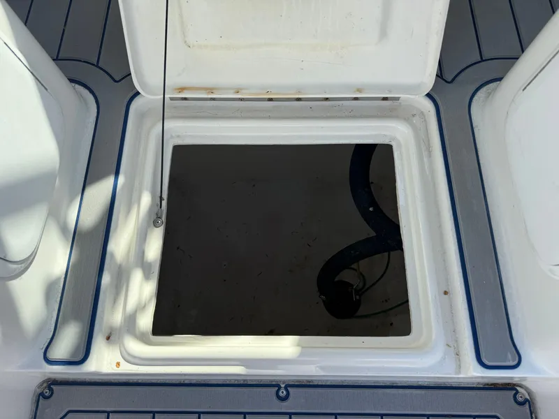 Slide: The Image of Open storage compartment on a 2004 Seaswirl Striper 2601 boat. - 17
