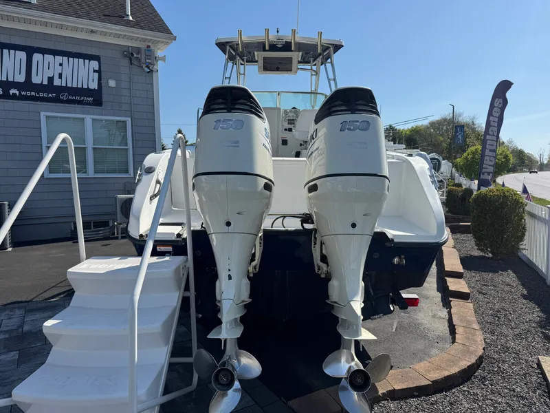 Slide: The Image of 2004 Seaswirl Striper 2601 with twin outboard engines displayed at an opening event. - 3