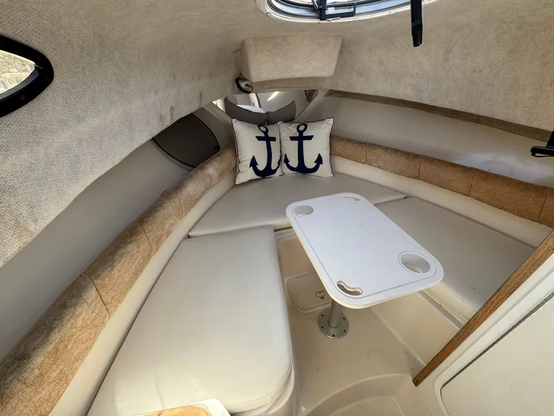 Slide: The Image of Interior of 2004 Seaswirl Striper 2601 with anchor pillow and table. - 8