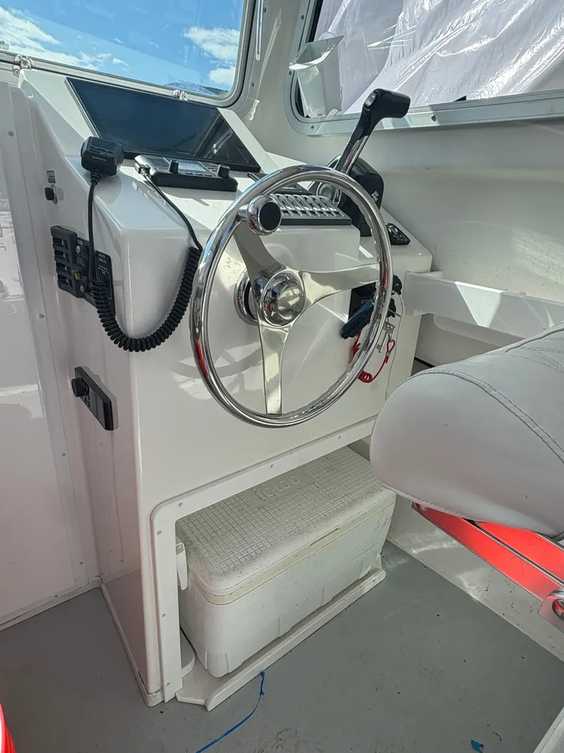 Slide: The Image of Steering console of 2019 Steiger Craft 23 Chesapeke with wheel and controls. - 3