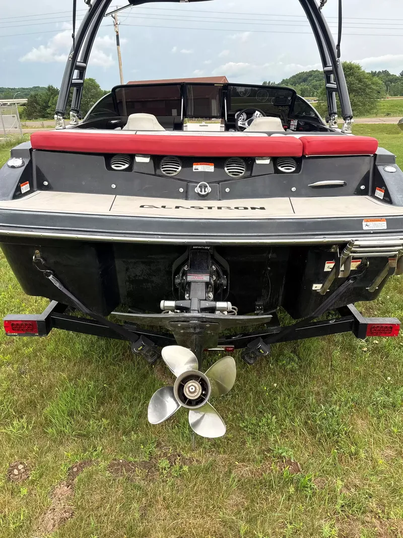Slide: The Image of The image shows the rear of a 2019 Glastron GTS185 boat on grass. - 8