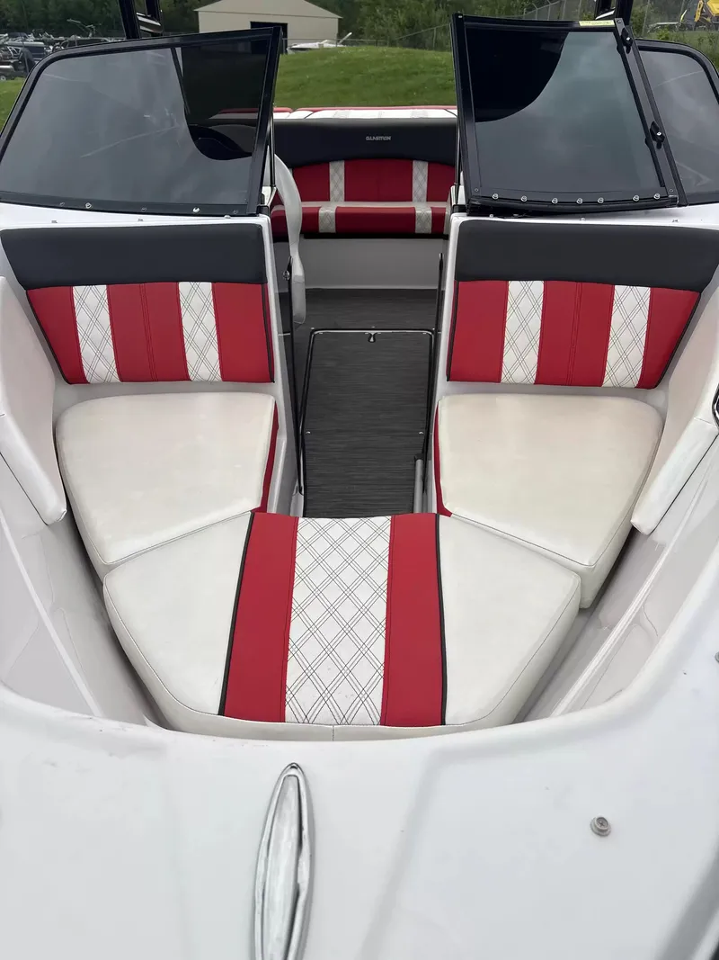 Slide: The Image of The image shows the interior of a 2019 Glastron GTS185 boat with red and white seating. - 3