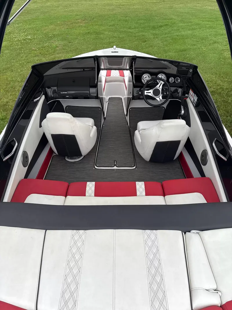 Slide: The Image of Interior of a 2019 Glastron GTS185 boat with white and red seating. - 7