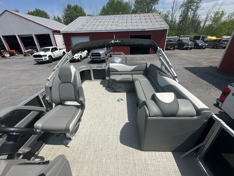 Slide: The Image of 2022 Avalon LSZ Cruise pontoon boat with gray seating outdoors. - 9