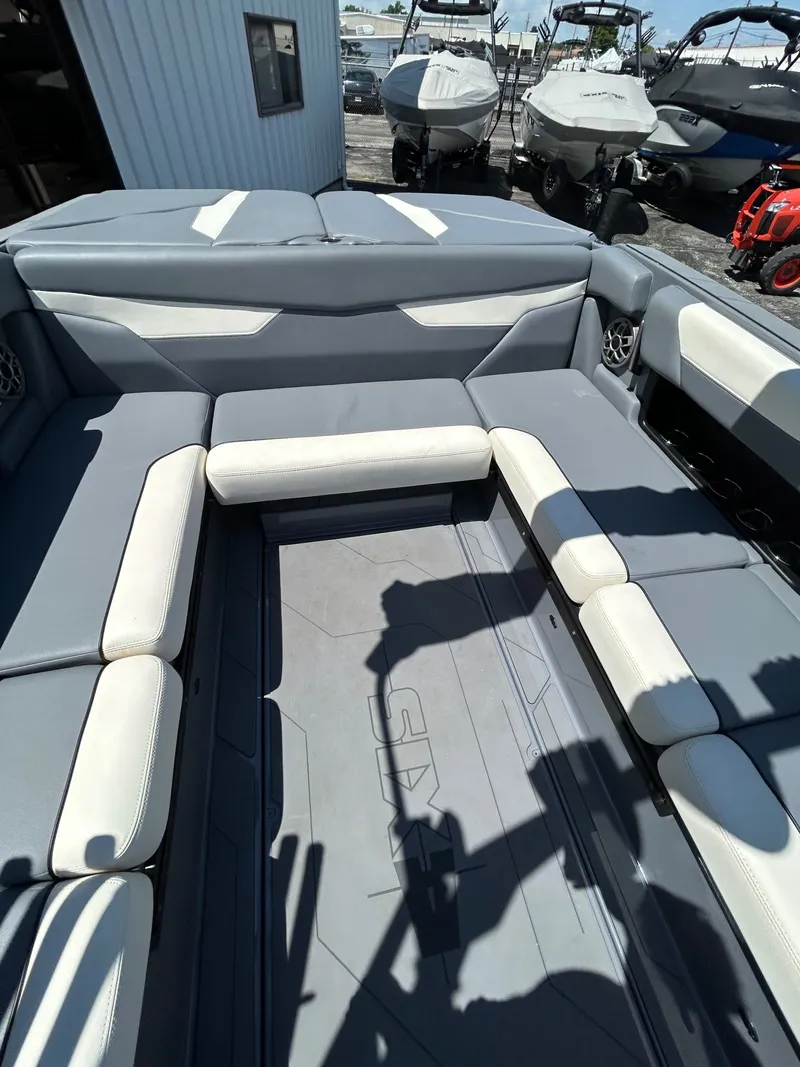 Slide: The Image of Interior of a 2023 Axis A24 boat with gray and white seating. - 15
