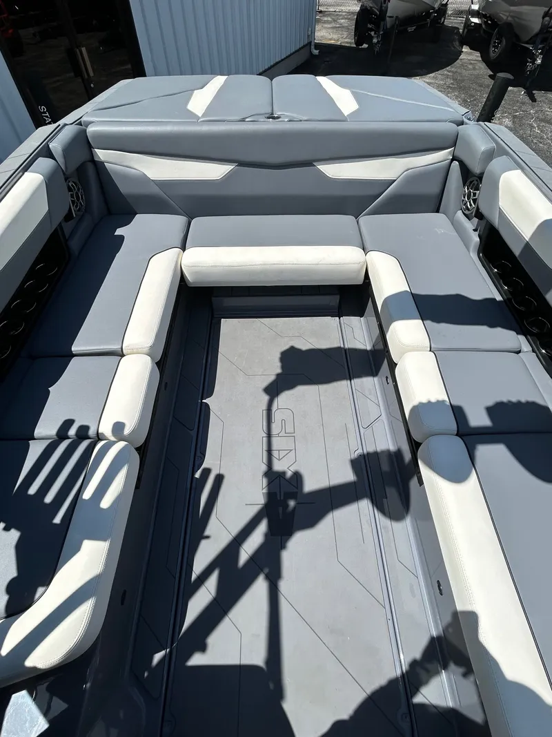 Slide: The Image of Interior of a 2023 Axis A24 boat with gray and white seating. - 21