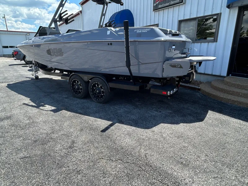 Slide: The Image of 2023 Axis A24 boat on trailer outside building. - 3