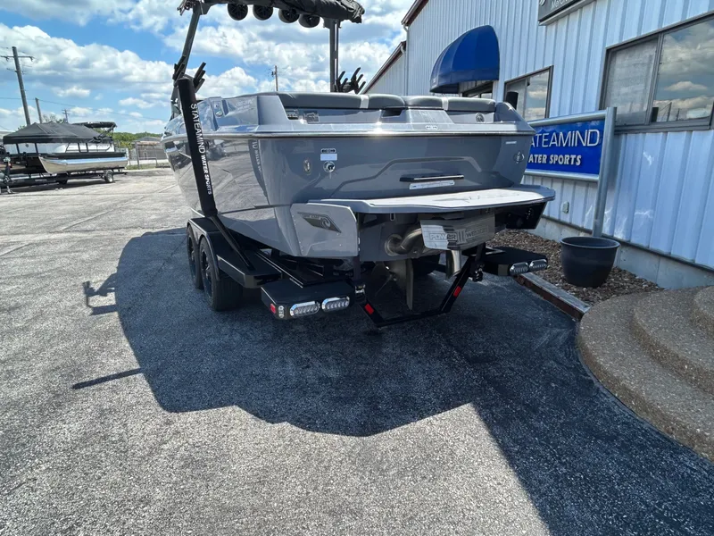 Slide: The Image of 2023 Axis A24 boat on trailer outside building. - 4