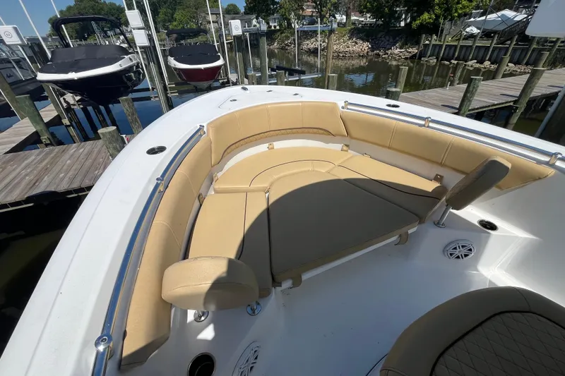 Slide: The Image of 2021 Sportsman Heritage 231 Center Console boat with tan seating at a marina dock. - 10