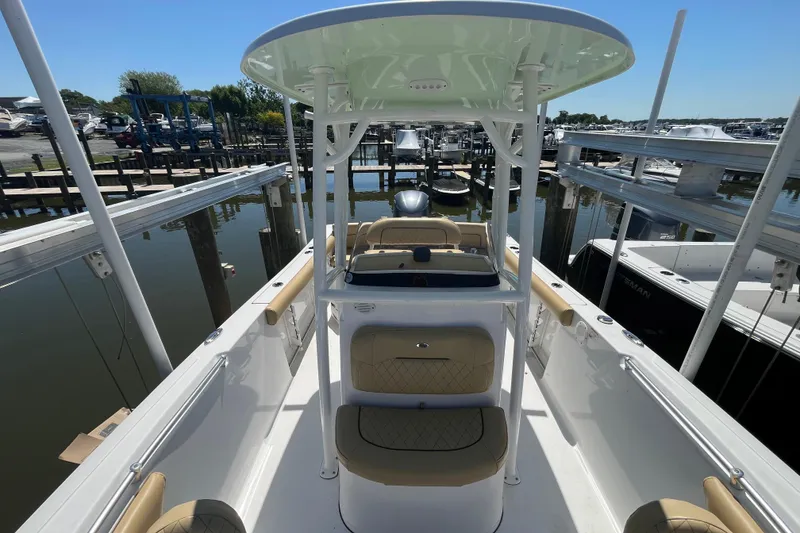 Slide: The Image of 2021 Sportsman Heritage 231 Center Console boat docked at marina, showcasing interior seating. - 11