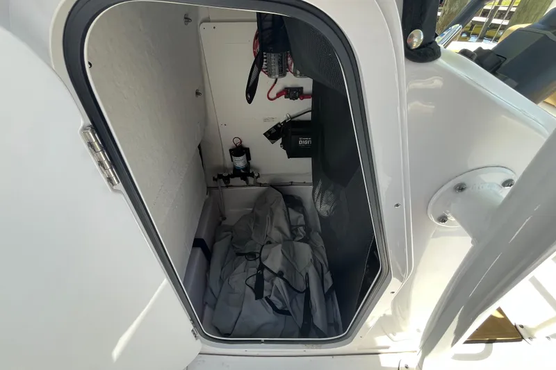 Slide: The Image of 2021 Sportsman Heritage 231 Center Console storage compartment interior view. - 6