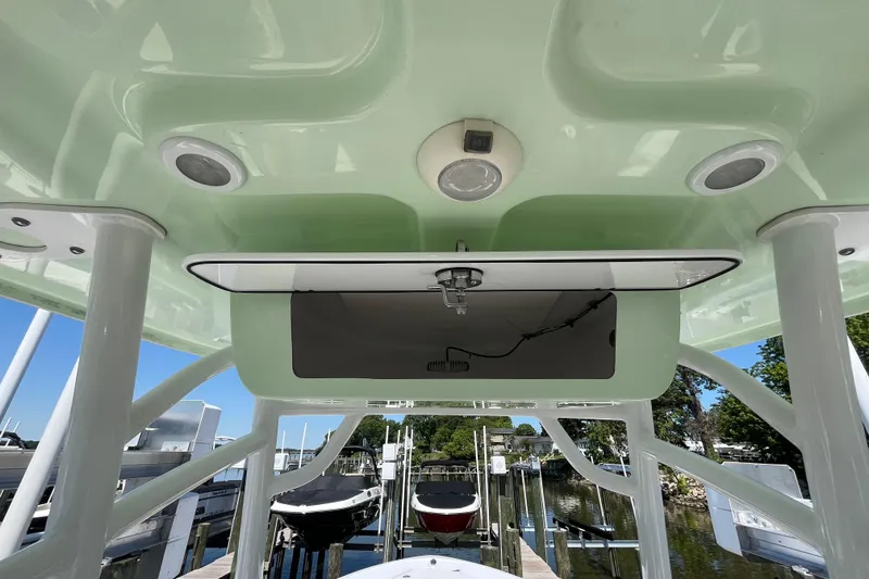 Slide: The Image of 2021 Sportsman Heritage 231 Center Console boat interior with speakers and storage compartment. - 8