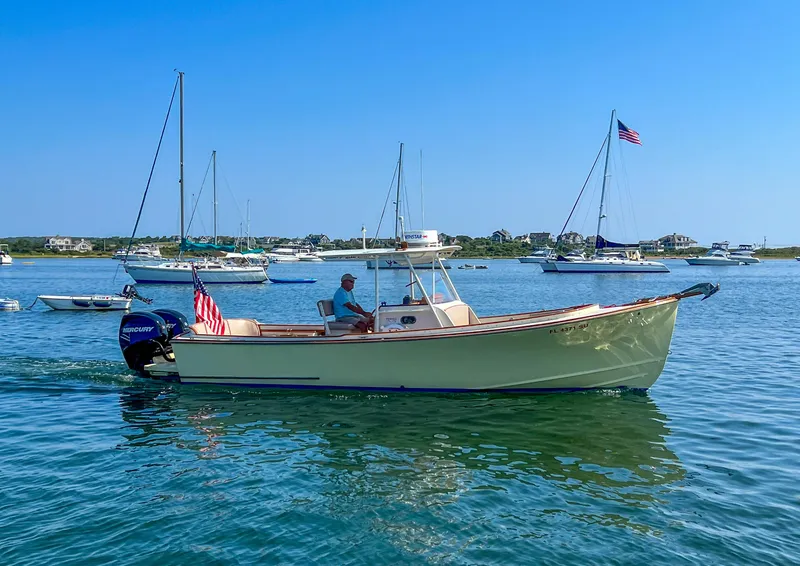 Slide: The Image of 2003 Padebco V27 Center Console boat cruising in a scenic harbor. - 1