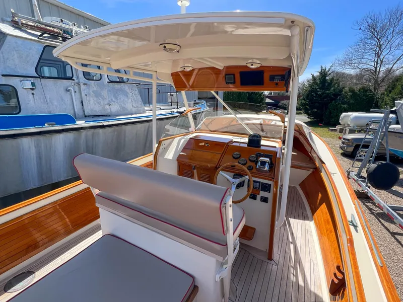 Slide: The Image of 2003 Padebco V27 Center Console boat with wooden accents and spacious seating. - 15