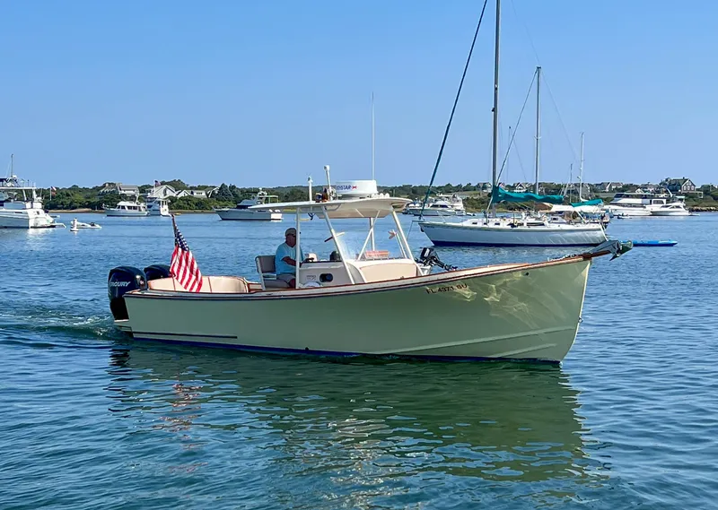 Slide: The Image of 2003 Padebco V27 Center Console boat cruising on a sunny day. - 2