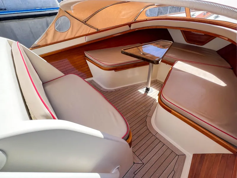 Slide: The Image of Luxurious interior of 2003 Padebco V27 Center Console with cushioned seating and wooden accents. - 20