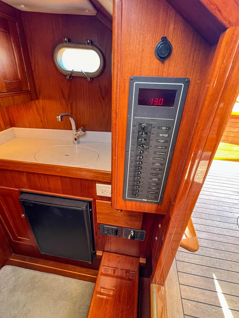 Slide: The Image of 2003 Padebco V27 Center Console interior with control panel and sink. - 26