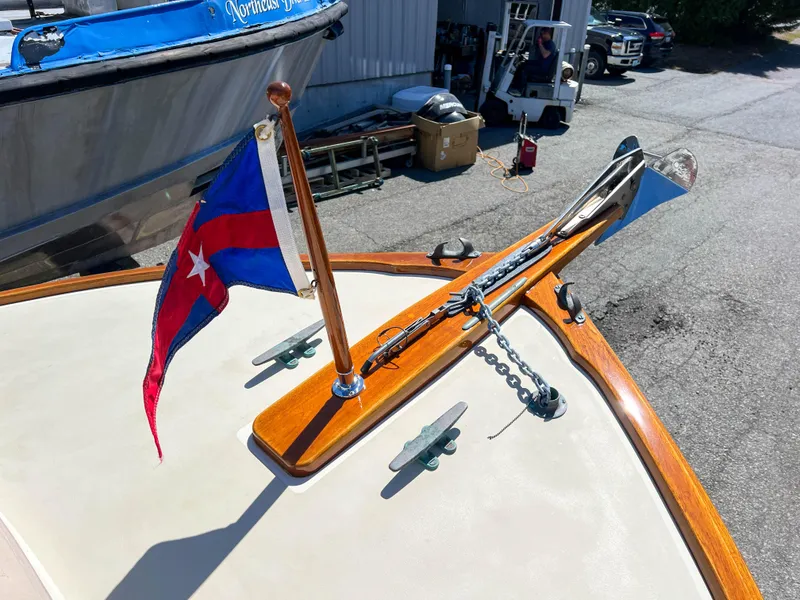 Slide: The Image of Padebco V27 Center Console 2003 with flag and anchor on deck. - 27
