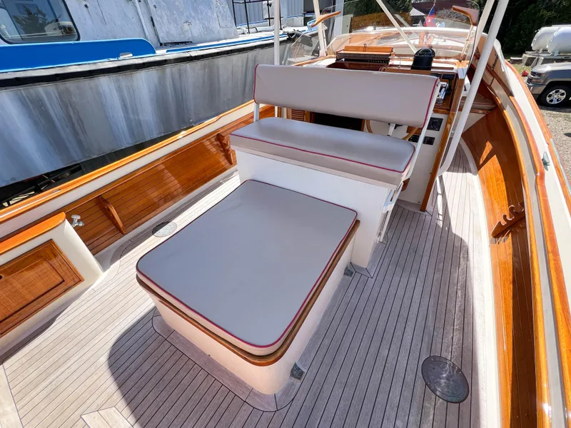 Slide: The Image of 2003 Padebco V27 Center Console boat interior with cushioned seating and wooden accents. - 30