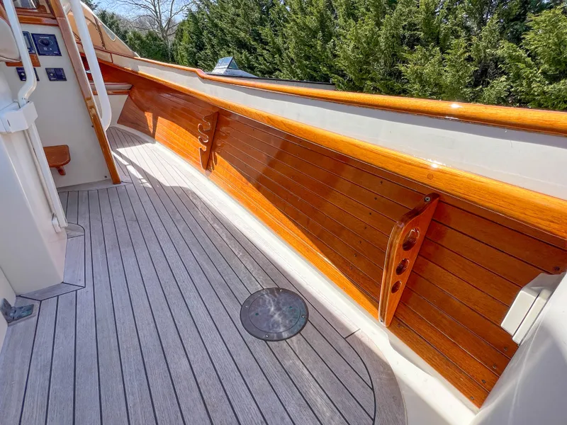 Slide: The Image of 2003 Padebco V27 Center Console boat with polished wood details and sleek deck design. - 32