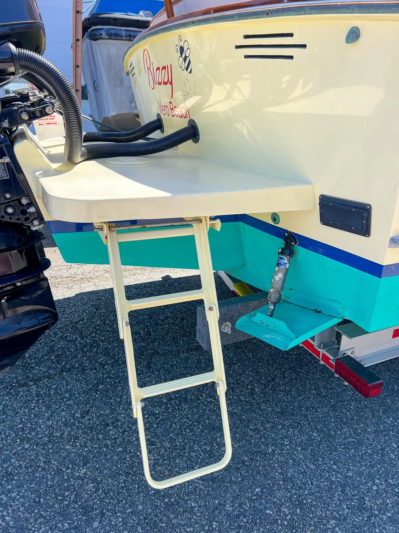 Slide: The Image of 2003 Padebco V27 Center Console boat with swim ladder and outboard motor. - 38