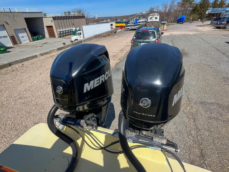 Slide: The Image of Twin Mercury outboard engines on a 2003 Padebco V27 Center Console boat. - 40
