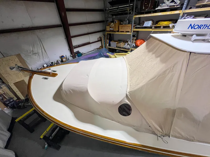 Slide: The Image of 2003 Padebco V27 Center Console boat in storage, covered and protected. - 42
