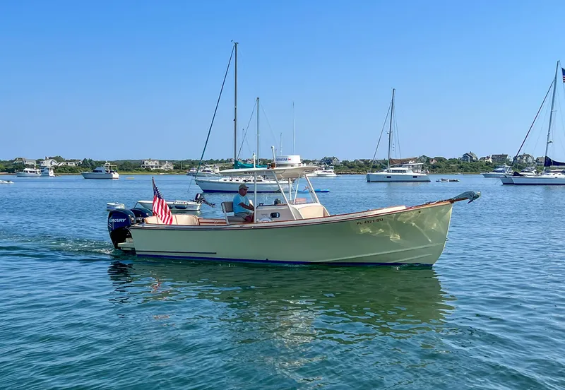 Slide: The Image of 2003 Padebco V27 Center Console boat cruising on a sunny day in a calm harbor. - 44