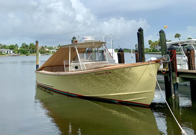 Slide: The Image of 2003 Padebco V27 Center Console boat docked on calm water. - 6