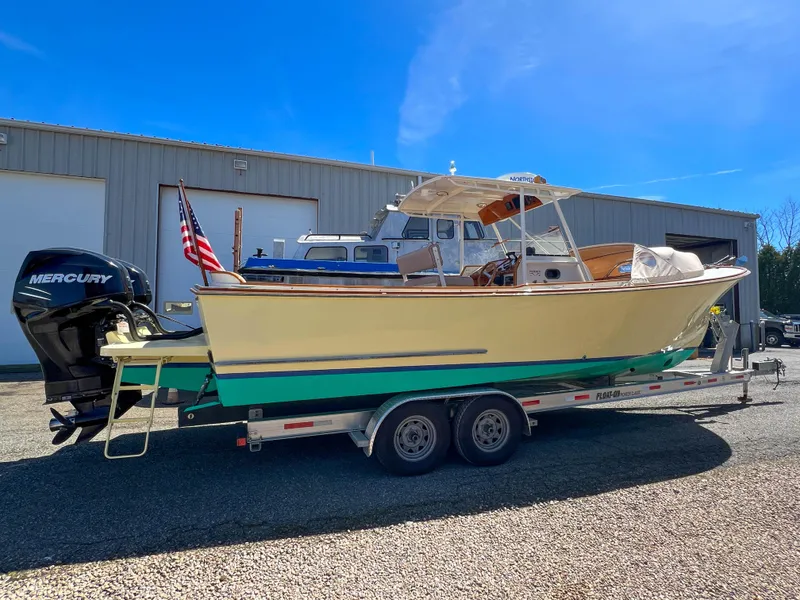 Slide: The Image of 2003 Padebco V27 Center Console boat on trailer, parked outdoors. - 9