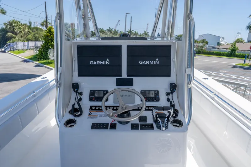 Slide: The Image of 2024 Contender 35 ST boat console with Garmin navigation systems and steering wheel. - 14
