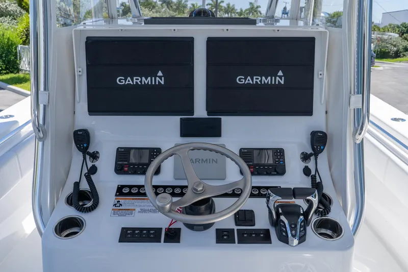 Slide: The Image of 2024 Contender 35 ST boat dashboard with dual Garmin displays and advanced controls. - 15