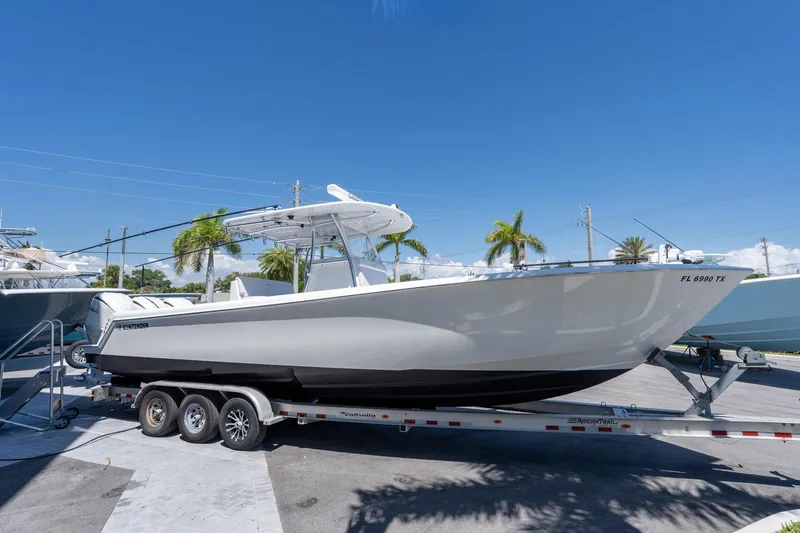 Slide: The Image of 2024 Contender 35 ST boat on trailer under clear blue sky. - 2