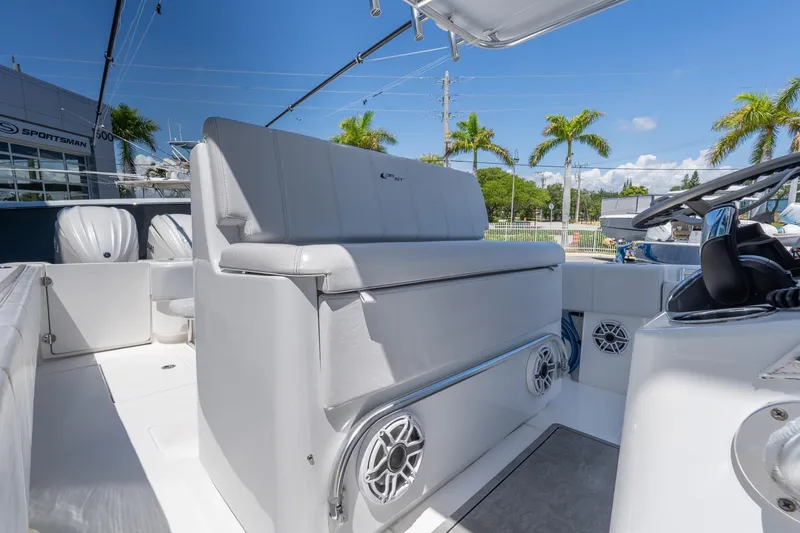 Slide: The Image of 2024 Contender 35 ST boat interior with seating, speakers, and helm, under clear blue sky. - 20