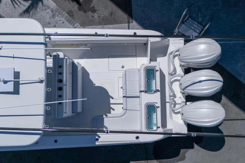Slide: The Image of Overhead view of 2024 Contender 35 ST boat with triple Yamaha engines. - 22
