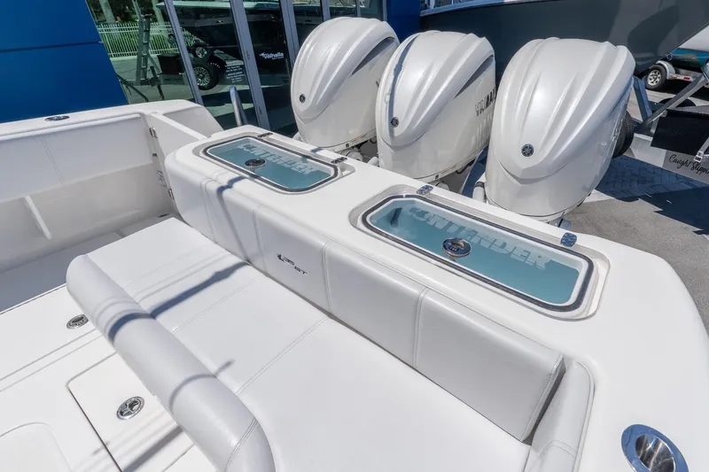 Slide: The Image of 2024 Contender 35 ST boat with triple outboard engines and sleek white seating. - 26