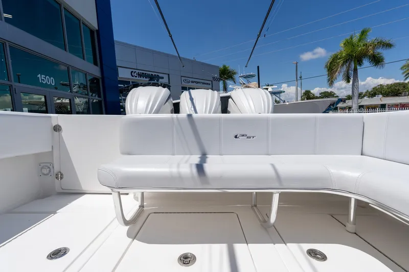 Slide: The Image of 2024 Contender 35 ST boat interior with white seating and triple engines. - 28