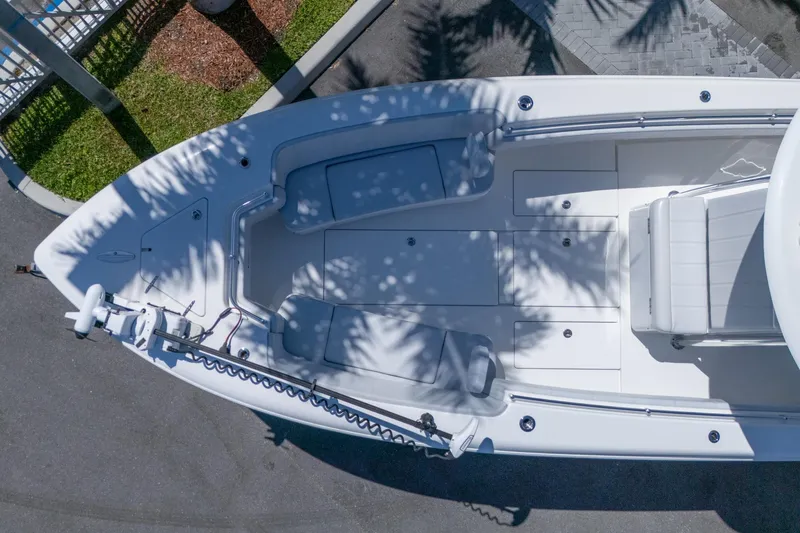 Slide: The Image of 2024 Contender 35 ST boat, aerial view, showcasing spacious deck and seating under palm shadows. - 8