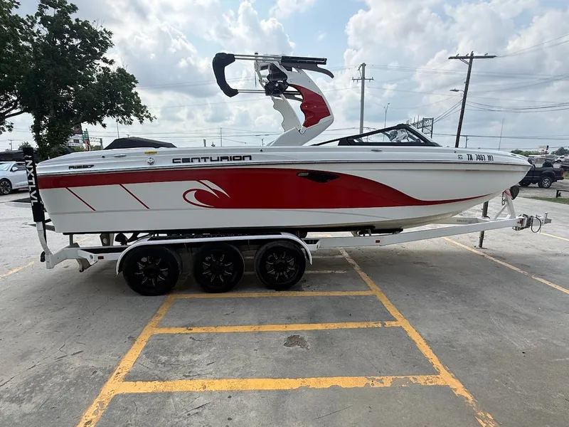 Slide: The Image of 2019 Centurion Ri257 boat on trailer, red and white design. - 10