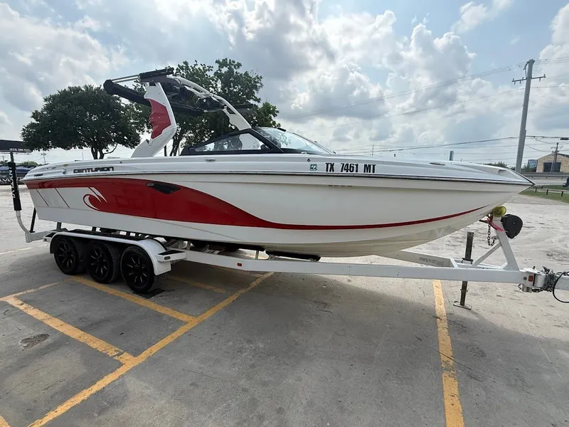 Slide: The Image of 2019 Centurion Ri257 boat on trailer, white with red accent. - 11