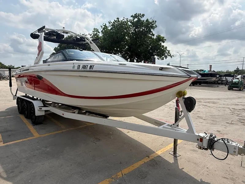 Slide: The Image of 2019 Centurion Ri257 boat parked on trailer outdoors. - 12